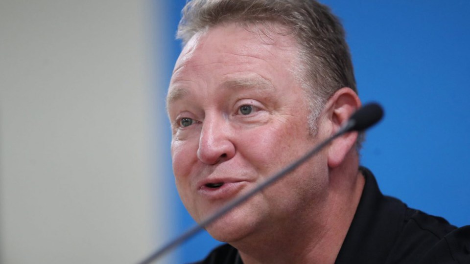 John Atkinson speaks into a microphone at a press conference